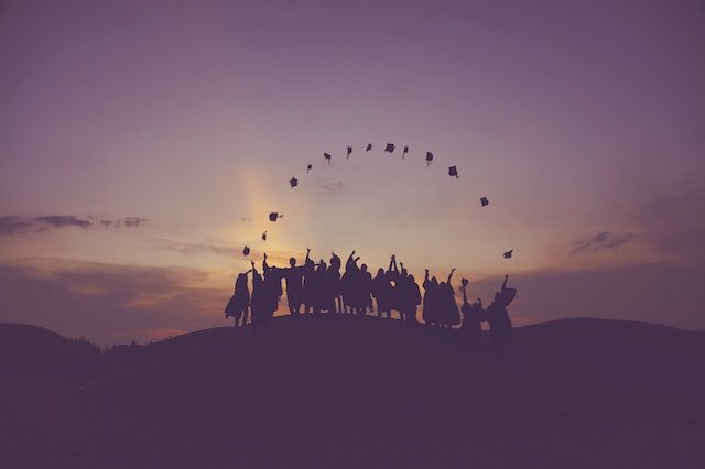 a group of graduates throwing their hats