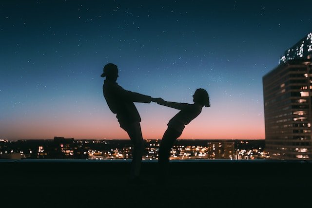 a couple holding hands at night