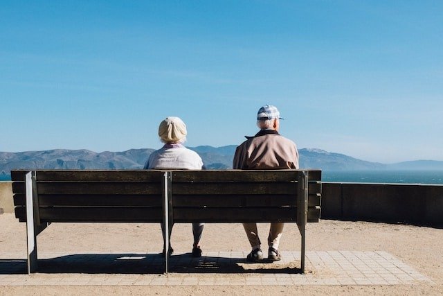 a senior couple sitting on a bench