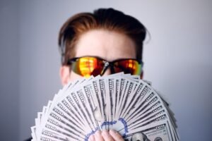 a guy holding lots of money