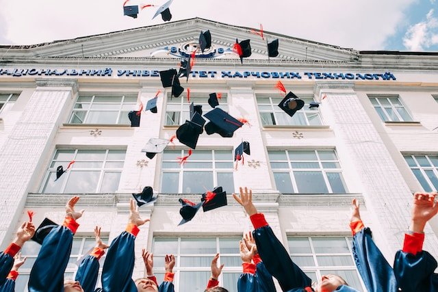 graduates throwing hats